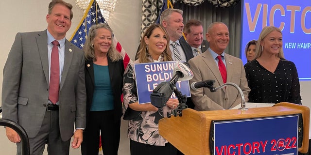 New Hampshire Gov. Chris Sununu, left, Republican National Committee chair Ronna McDaniel, center, and Republican Senate nominee Don Bolduc, second from right, are shown at a New Hampshire GOP unity breakfast in Concord, New Hampshire, on Sept. 15, 2022.