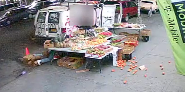 The suspect and victim then crash into the fruit stand, sending items tumbling to the ground.
