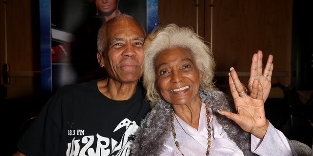 Kyle Johnson often attended "Star Trek" conventions with mother Nichelle Nichols (seen in 2019). He said her final deep-space mission would be a true honor.