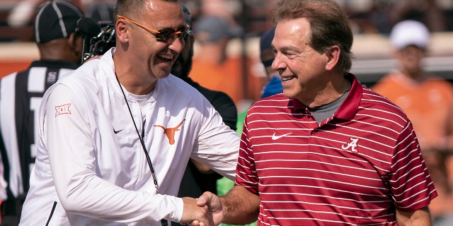 Texas head coach Steve Sarkisian (left) and Alabama head coach Nick Saban meet on the field during the team warm-up before a game on Sept. 10, 2022 in Austin, Texas. 