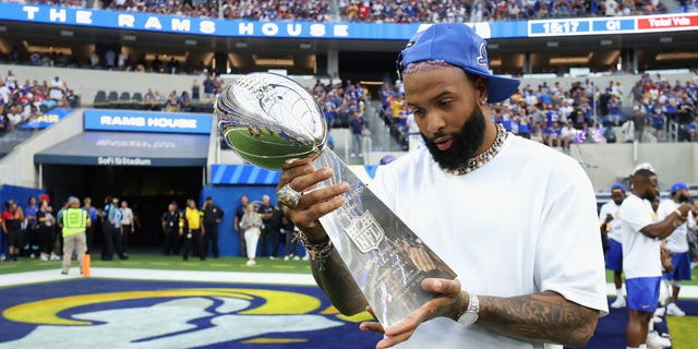 Odell Beckham Jr. holds up the Super Bowl LVI trophy before a game between the Los Angeles Rams and the Buffalo Bills at SoFi Stadium on September 8, 2022 in Inglewood, California.