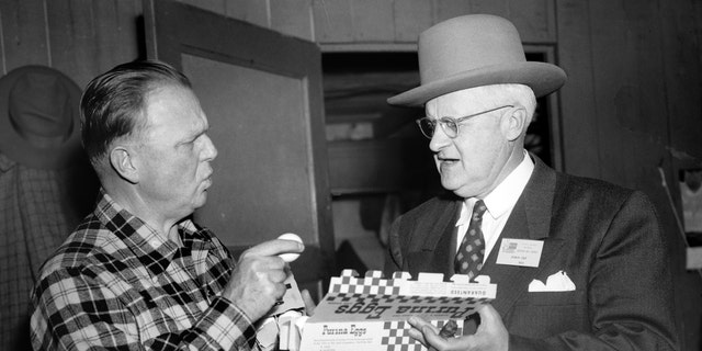 George Dewey Hay, right, the "Solemn Old Judge" and founder of the Grand Ole Opry on WSM radio, inspects a box of Purina brand eggs with Dr. Lew Childre circa 1951 in Nashville, Tennessee.