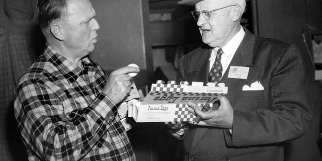 George Dewey Hay, right, the "Solemn Old Judge" and founder of the Grand Ole Opry on WSM radio, inspects a box of Purina brand eggs with Dr. Lew Childre circa 1951 in Nashville, Tennessee.