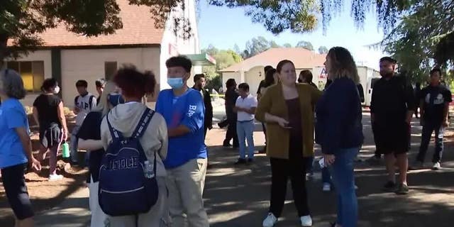 Parents and students congregate outside church where they are reuniting after Oakland school shooting. Sept. 28, 2022