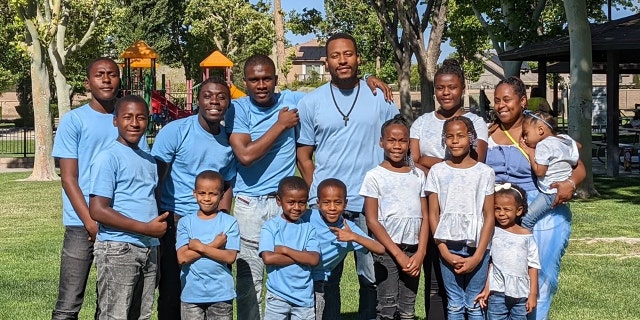 The Purnell family are shown here. Mom Iris Purnell (far right, holding a little one) recommends waiting to buy school supplies until later in the season.