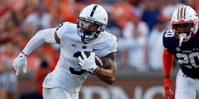 Penn State wide receiver Parker Washington carries the ball against Auburn during the second half in Auburn, Alabama, on Sept. 17, 2022.