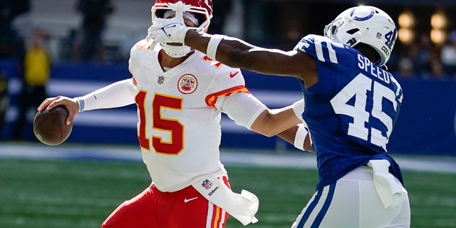 Kansas City Chiefs quarterback Patrick Mahomes, #15, is chased by Indianapolis Colts' E.J. Speed, #45, during the second half of an NFL football game, Sunday, Sept. 25, 2022, in Indianapolis.