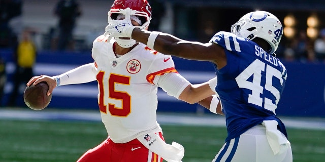 Kansas City Chiefs quarterback Patrick Mahomes, #15, is chased by Indianapolis Colts' E.J. Speed, #45, during the second half of an NFL football game, Sunday, Sept. 25, 2022, in Indianapolis.