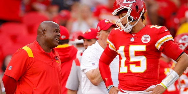 Kansas City Chiefs offensive coordinator Eric Bieniemy speaks with Patrick Mahomes #15 of the Kansas City Chiefs during pregame warmups prior to the game against the Los Angeles Chargers at Arrowhead Stadium on Sept. 15, 2022 in Kansas City, Missouri.