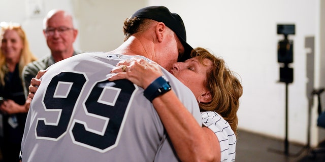 Aaron Judge, #99 of the New York Yankees, hugs his mother, Patty, after defeating the Toronto Blue Jays and tying Roger Maris AL home run record at Rogers Centre on Wednesday, Sept. 28, 2022 in Toronto.