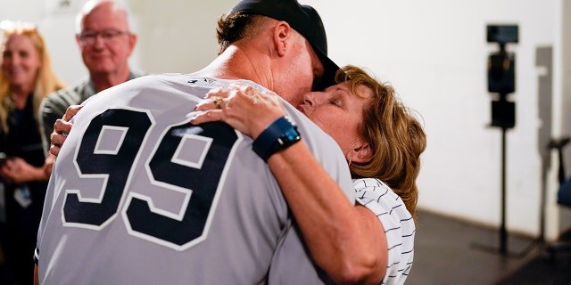 Aaron Judge, #99 of the New York Yankees, hugs his mother, Patty, after defeating the Toronto Blue Jays and tying Roger Maris AL home run record at Rogers Centre on Wednesday, Sept. 28, 2022 in Toronto.