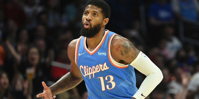 Apr 9, 2022; Los Angeles, California, USA; Los Angeles Clippers guard Paul George (13) runs down court after a three point basket against the Sacramento Kings in the second half at Crypto.com Arena.