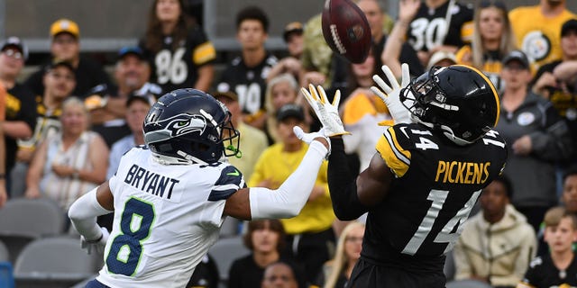 George Pickens (14) of the Pittsburgh Steelers makes a catch for a 26-yard touchdown reception as Coby Bryant (8) of the Seattle Seahawks defends in the first quarter during a preseason game at Acrisure Stadium Aug. 13, 2022, in Pittsburgh.