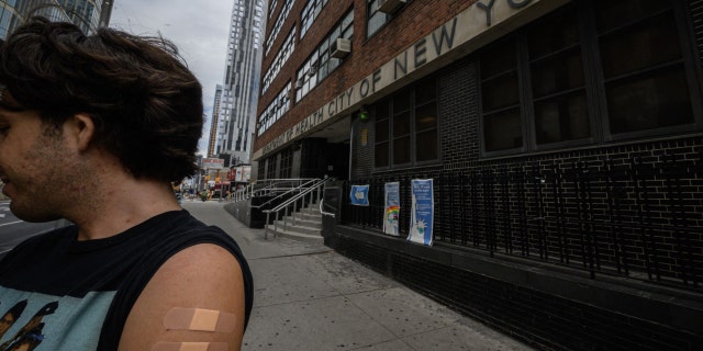 A man, who wished to remain anonymous, displays his arm where he received a polio vaccination, outside a health clinic in Brooklyn, New York on August 17, 2022.