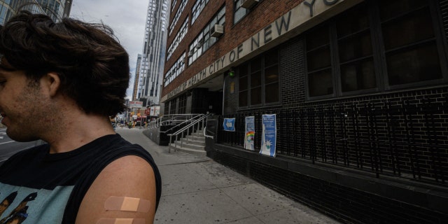 A man who requested anonymity shows his polio-vaccinated arm outside a clinic in Brooklyn, New York, on August 17, 2022. 