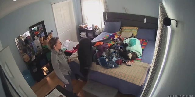Smith initially thought that the person under the pile of clothes was her husband and called his name, but got no response. She then realized that a stranger was on the bed.