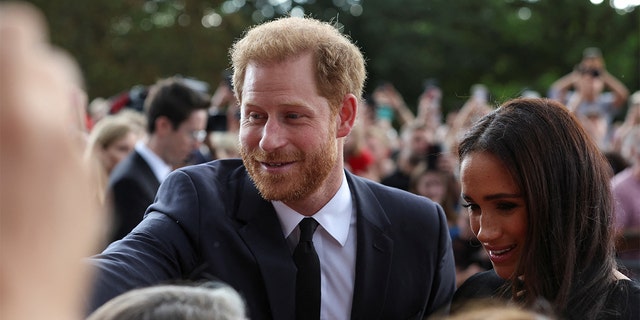 British Prince Harry and Meghan, the Duchess of Sussex greet people as they walk out of Windsor Castle, following the death of Queen Elizabeth, in Windsor, Britain on September 10, 2022. 