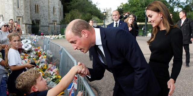 Britain's Prince William and Princess Catherine of Wales greet the public outside Windsor Castle after the death of Queen Elizabeth of England on September 10, 2022 in Windsor, England. 