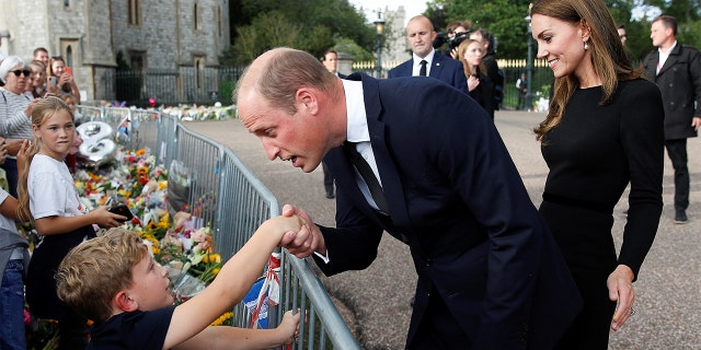 Britain's Prince William and Princess Catherine of Wales greet the public outside Windsor Castle after the death of Queen Elizabeth of England on September 10, 2022 in Windsor, England. 