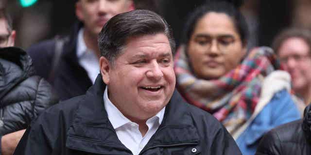 Illinois Gov. J.B. Pritzker listens to speakers during a transgender support rally at Federal Building Plaza on April 27, 2022, in Chicago, Illinois.
