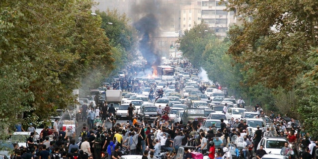 FILE - In this photo taken by an individual not employed by the Associated Press and obtained by the AP outside Iran, protesters chant slogans during a protest over the death of a woman who was detained by the morality police, in downtown Tehran, Iran, Sept. 21, 2022.  