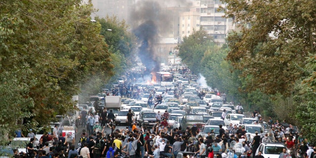 In this photo taken by an individual not employed by the Associated Press and obtained by the AP outside Iran, protesters chant slogans during a protest over the death of a woman who was detained by the morality police, in downtown Tehran, Iran, Sept. 21, 2022.  