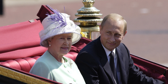Russian President Vladimir Putin is accompanied by Queen Elizabeth II during his state visit on June 24, 2003, in London.