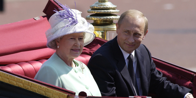 Russian President Vladimir Putin is accompanied by Queen Elizabeth II during his state visit June 24, 2003, in London.