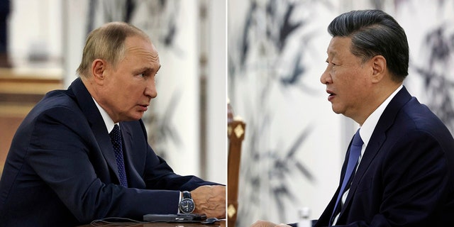Chinese President Xi Jinping talks to Russian President Vladimir Putin at the SCO summit in Samarkand, Uzbekistan, Thursday, Sept. 15, 2022.