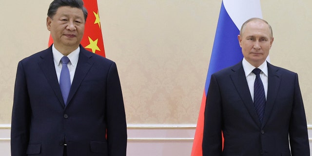 Chinese President Xi Jinping, left, and Russian President Vladimir Putin pose for a photo on the sidelines of the Shanghai Cooperation Organization Summit in Samarkand, Uzbekistan, Thursday, Sept. 15, 2022.