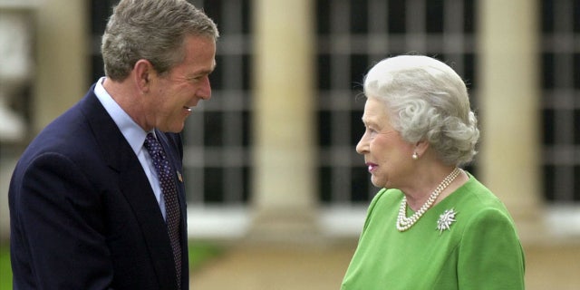 FILE – President George W. Bush shakes hands with Britain's Queen Elizabeth before departing from Buckingham Palace in London, November 21, 2003. 