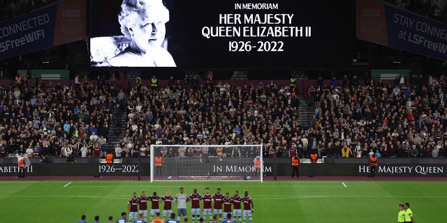 Team players stand on the pitch during minutes silence following the death of Queen Elizabeth II prior the Group B Europa Conference League soccer match between West Ham and FCSB Steaua Bucharest at London Stadium in London, Thursday, Sept. 8, 2022.