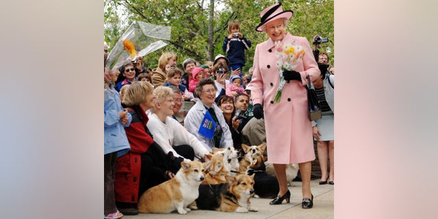 Queen Elizabeth II greeted by local corgi enthusiasts as she departs the Legislature Building during a trip to Canada in 2005. 