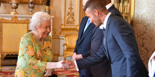 Britain's Queen Elizabeth II greets former soccer star David Beckham before the Queen's Young Leaders Awards Ceremony June 26, 2018.