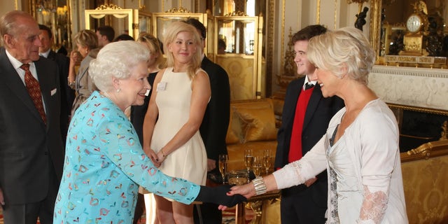 Queen Elizabeth II shook hands with Dame Helen Mirren and singer Ellie Goulding watched during a reception honoring young people in the performing arts at Buckingham Palace in 2011.