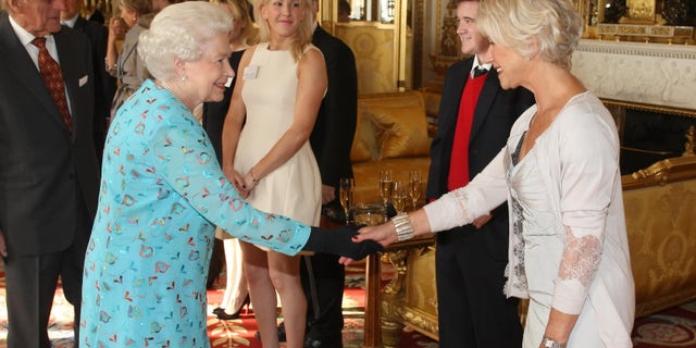 Queen Elizabeth II shook hands with Dame Dame Helen Mirren while singer Ellie Goulding looked on during a reception to celebrate young people in the performing arts at Buckingham Palace in 2011.