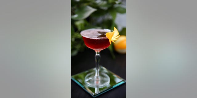 This cocktail is topped with an orange for a colorful twist.