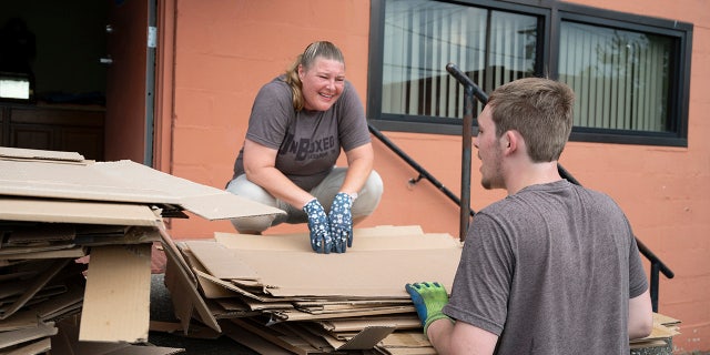 Ashton Gilbert chats with his mother, Ashley York, as they collect boxes at a local business.
