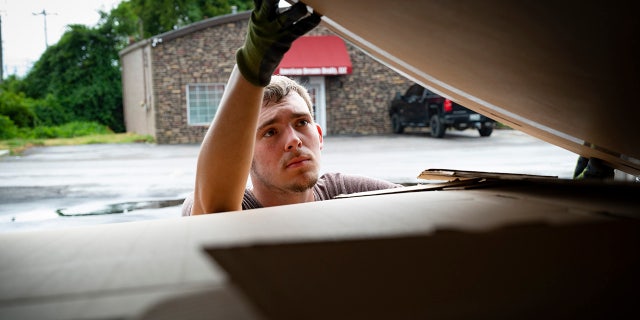 Ashton Gilbert is pictured hard at work as he loads boxes into his UnBoxed van in Tennessee.