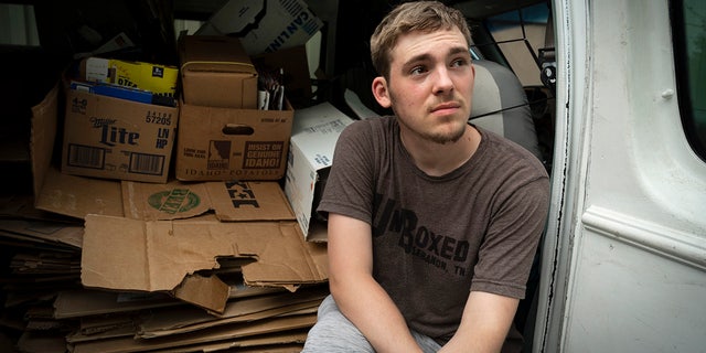 Unboxed owner Ashton Gilbert relaxes in his van full of cardboard boxes.