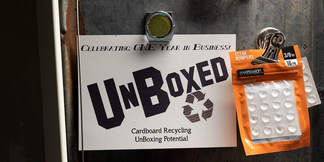 An unboxed cardboard recycling business ad.