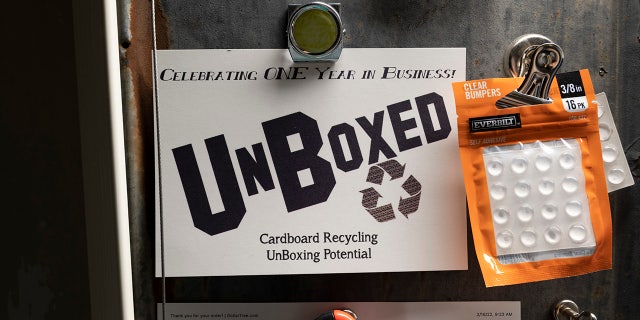 An UnBoxed cardboard recycling business advertisement.