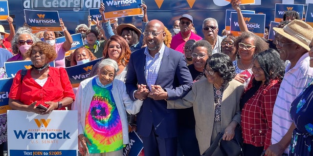 Sen.  Raphael Warnock of Georgia, with supporters at a rally for seniors in Atlanta on Sept.  26.