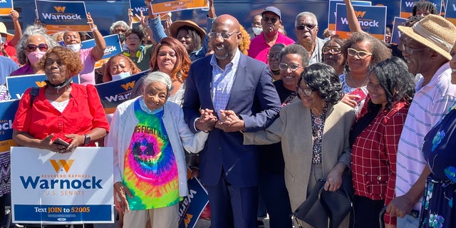 Sen.  Raphael Warnock of Georgia, with supporters at a rally for seniors in Atlanta on Sept.  26.