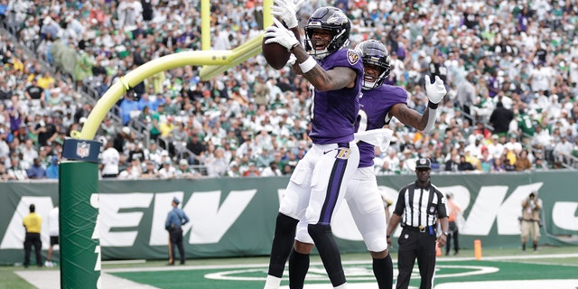 Baltimore Ravens Rashod Bateman and Demarcus Robinson celebrate after scoring a touchdown against the New York Jets, Sunday, Sept. 11, 2022, in East Rutherford, New Jersey.