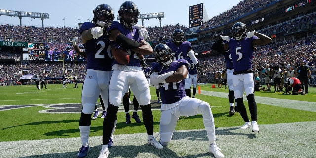 Baltimore Ravens safety Marcus Williams (32) celebrates with teammates after intercepting a pass during the first half against the Miami Dolphins in Baltimore on September 18, 2022.