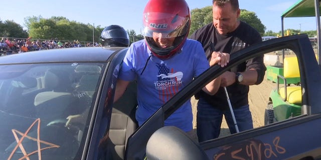 Michigan Supreme Court Justice Richard Bernstein, who is blind, gets into a car to drive for the first time at the Genesee County fairgrounds in Mt. Morris, Mich., on Tuesday, Aug. 23, 2022. Sheriff Chris Swanson, rear, rode in the passenger seat and gave instructions.