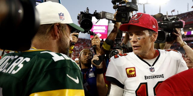 Aaron Rodgers of the Green Bay Packers, left, talks with Tom Brady of the Tampa Bay Buccaneers after the game at Raymond James Stadium in Tampa, Florida, on Sept. 25, 2022.