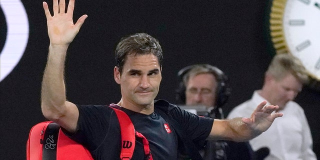 Roger Federer waves as he leaves Rod Laver Arena following his loss to Novak Djokovic at the Australian Open in Melbourne, Jan. 30, 2020.