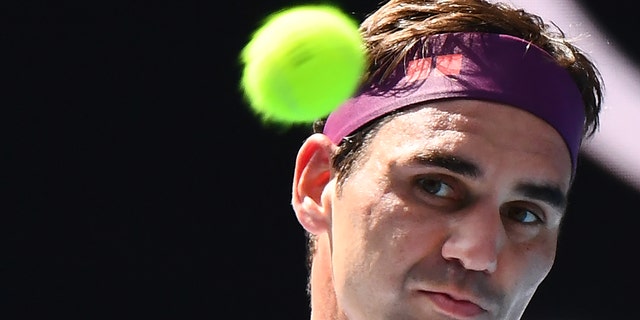 Switzerland's Roger Federer hits a return against Tennys Sandgren, of the U.S., during their men's singles quarter-final match on day nine of the Australian Open tennis tournament in Melbourne on January 28, 2020. 